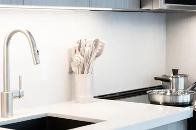 a kitchen counter with a vase filled with utensils at Studio Gem in the lovely Waterfront Communities in Toronto