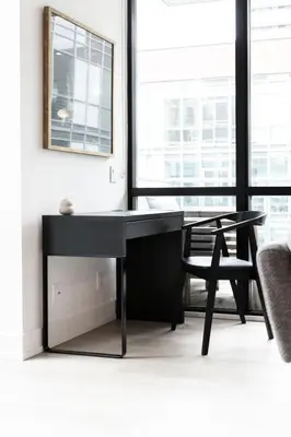 a black desk in a room with a chair at Studio Gem in the lovely Waterfront Communities in Toronto