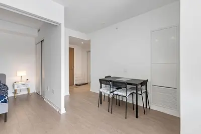 a dining room with a black table and chairs at Downtown 2 bedroom Condo with Private Balcony in Toronto