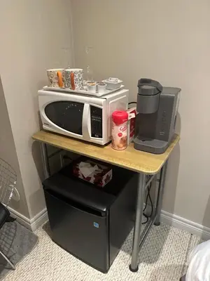 a table with a microwave and a toaster oven on it at Toronto downtown Woodbine beaches private cozy room in Toronto
