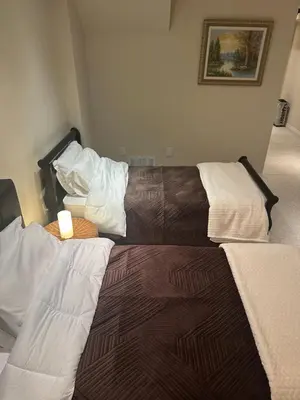 two beds sitting in a room with at Toronto downtown Woodbine beaches private cozy room in Toronto