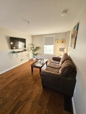 a living room with a couch and a table at Spacious 2-bedroom ground floor unit near beach in Cobourg