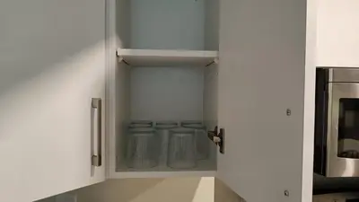 a kitchen with white cabinets with glass jars at Garden View in Schomberg