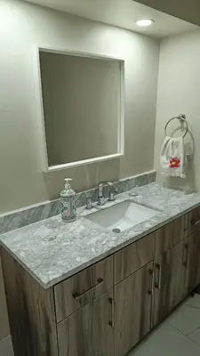 a bathroom with a sink and a large mirror at Garden View in Schomberg