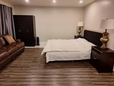 a bedroom with a bed and a couch at Garden View in Schomberg