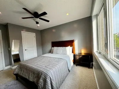 a bedroom with a bed and a ceiling fan at 3500 SqFt - Modern and Comfort - 4 BDRM Getaway - Relax - Unwind - Explore - Near Airport & Toronto Downtown in Brampton