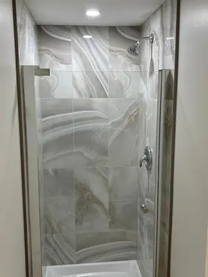 a shower with a glass door in a bathroom at One-Bedroom Unit at VISTA HILL in Waterloo