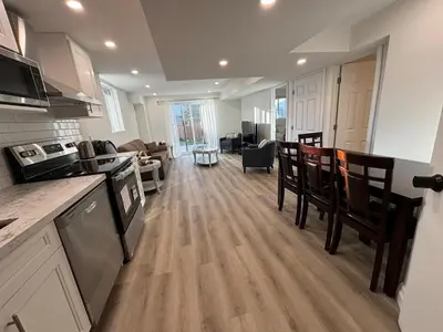 a kitchen and living room with wooden floors and a counter top at One-Bedroom Unit at VISTA HILL in Waterloo