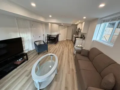 a living room with a couch and a tv at One-Bedroom Unit at VISTA HILL in Waterloo