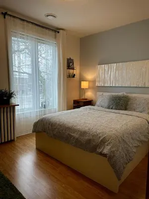 a bedroom with a large bed and a window at Girls Night Out in Toronto