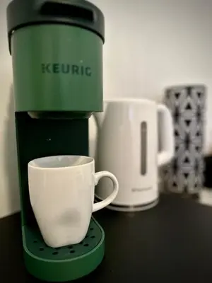 a coffee maker with a cup on a counter at Girls Night Out in Toronto