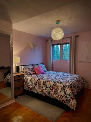 a bedroom with a bed and a window at Girls Night Out in Toronto