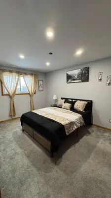 a bedroom with a large bed and a window at Welcome to our cozy private Home in Pickering