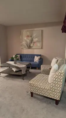 a living room with a blue couch and chairs at Welcome to our cozy private Home in Pickering