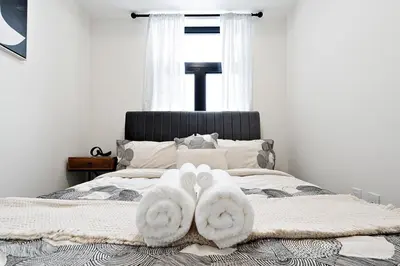a bedroom with a bed with towels on it at Cozy 2BR Suite with Parking & Close to Niagara Falls and Sleeps 6 Guests in Niagara Falls