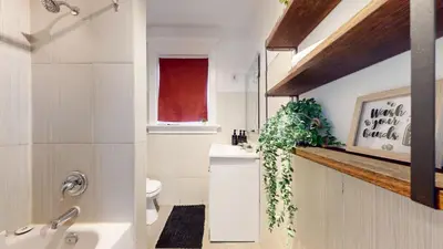 a bathroom with a sink and a toilet and a window at Comfortable & Spacious Private Room with Ensuite in Corso Italia in Toronto