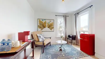 a kitchen with a red refrigerator and a table at Comfortable & Spacious Private Room with Ensuite in Corso Italia in Toronto