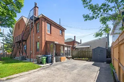 an old brick building with a spiral staircase on it at Comfortable & Spacious Private Room with Ensuite in Corso Italia in Toronto