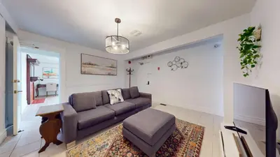 a living room with a couch and a table at Comfortable & Spacious Private Room with Ensuite in Corso Italia in Toronto