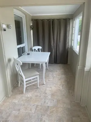 a white table and two chairs in a room at Ultra Close to Clifton Hill and the Falls & Wonderful Free Breakfast Delivered Daily in Niagara Falls