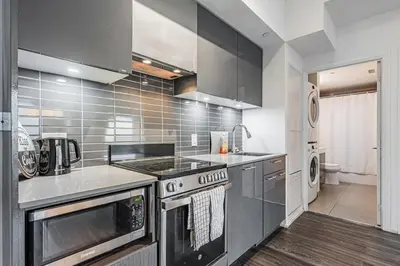 a kitchen with a stove and a sink at 2BR Condo close to Eaton Center in Toronto