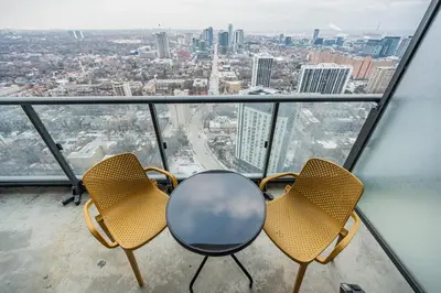 two chairs and a table on top of a building at 2BR Condo close to Eaton Center in Toronto