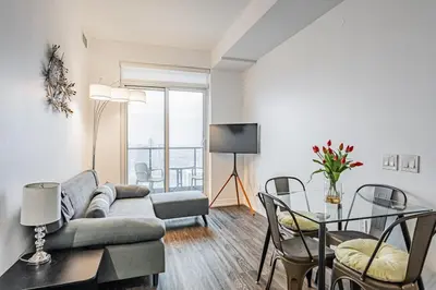 a living room with a couch and a table at 2BR Condo close to Eaton Center in Toronto