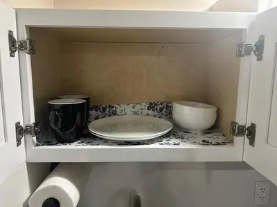 a cabinet with a plate and a coffee maker on a counter at Luxury Basement-Private Bdr & Bathroom with free parking In Toronto in Toronto