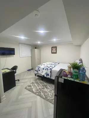 a bedroom with a bed and a dresser and a desk at Luxury Basement-Private Bdr & Bathroom with free parking In Toronto in Toronto