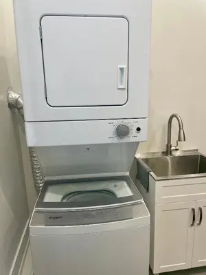 a washing machine in a kitchen with a sink at Luxury Basement-Private Bdr & Bathroom with free parking In Toronto in Toronto