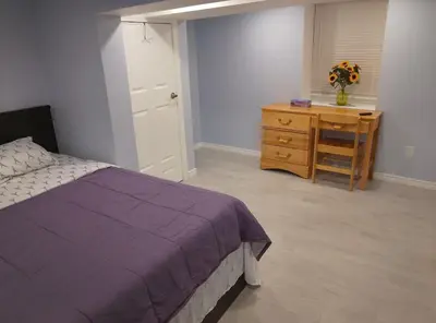 a bedroom with a bed and a dresser and a desk at Midtown Toronto suite in Toronto