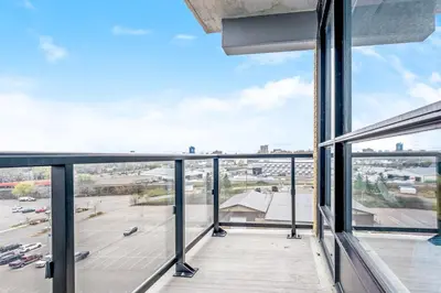 an open balcony with a view of a parking lot at DT High Rise Condo w Private Patio and View in Kitchener