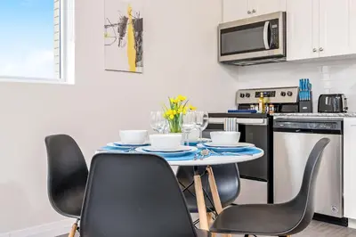 a kitchen with a table with chairs and a microwave at DT High Rise Condo w Private Patio and View in Kitchener