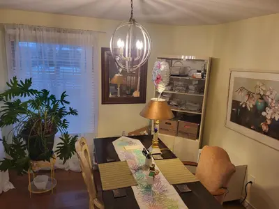 a dining room with a table and a chandelier at 308 Delancey in Hamilton