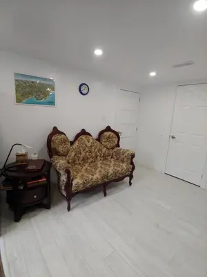 a living room with a couch and a table at Two bedroom on Toronto Greenhills in Toronto