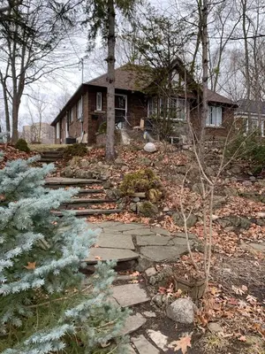a house with a pathway in front of a house at Two bedroom on Toronto Greenhills in Toronto