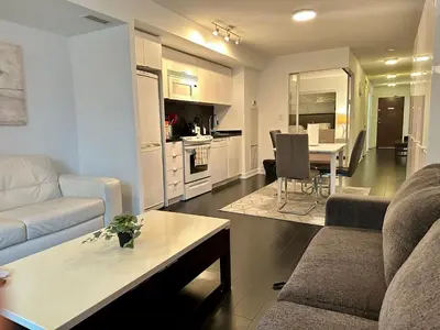 a living room with a couch and a table at Spacious & Central 1 bdrm 2 real beds in Toronto