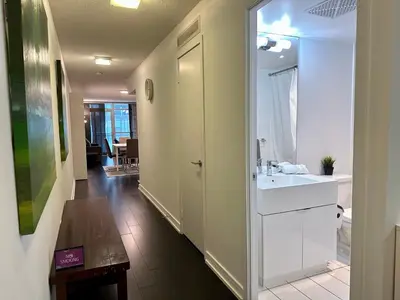a bathroom with a sink and a mirror at Spacious & Central 1 bdrm 2 real beds in Toronto