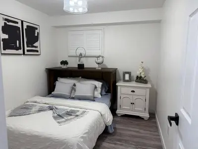 a bedroom with a bed and a night stand with a lamp at Modern & Stylish 2BR Apartment 658 in Peterborough