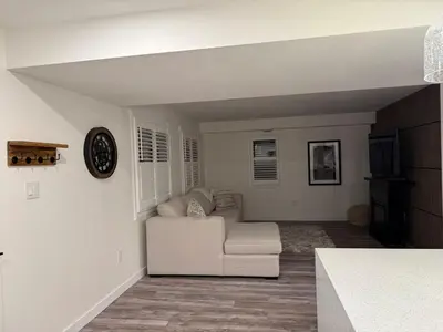 a white living room with a couch and a tv at Modern & Stylish 2BR Apartment 658 in Peterborough