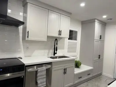 a kitchen with white cabinets and a sink at Modern & Stylish 2BR Apartment 658 in Peterborough