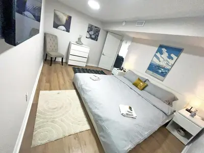 a bedroom with a large bed and a desk at Hamilton Chic Retreat - Cozy Winter Getaway in Hamilton