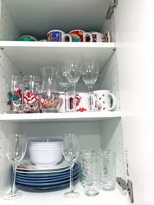a shelf filled with glasses and plates and dishes at Hamilton Chic Retreat - Cozy Winter Getaway in Hamilton