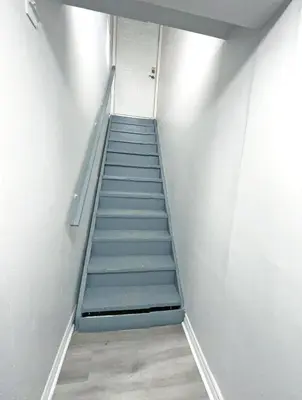 a staircase in a room with a stair case at Hamilton Chic Retreat - Cozy Winter Getaway in Hamilton