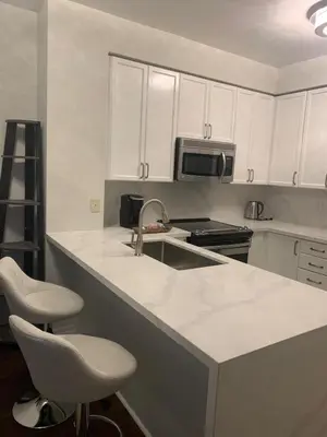 a kitchen with white cabinets and a counter top at Cityscape in Mississauga