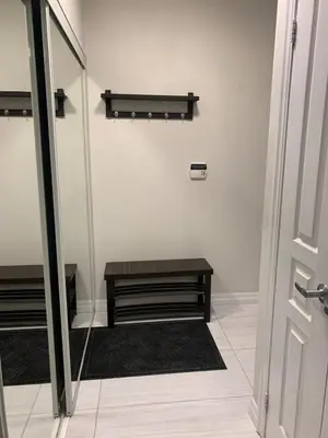 a room with a bench and a table and a door at Cityscape in Mississauga