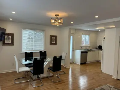 a kitchen and dining room with a table and chairs at Serenity Charm - Walk in Town, Shaw, Hottub in Niagara on the Lake