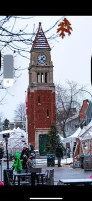 a tall clock tower with a clock on it at Serenity Charm - Walk in Town, Shaw, Hottub in Niagara on the Lake