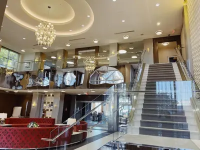 a lobby with a staircase and a chandelier at Urban Oasis - Modern 1 bedroom w pool access free parking in Toronto