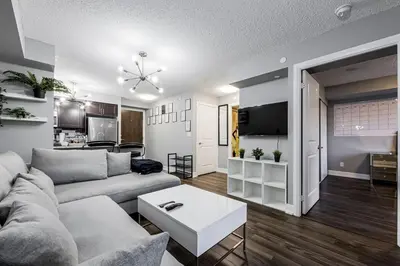 a living room with a couch and a table at Urban Oasis - Modern 1 bedroom w pool access free parking in Toronto